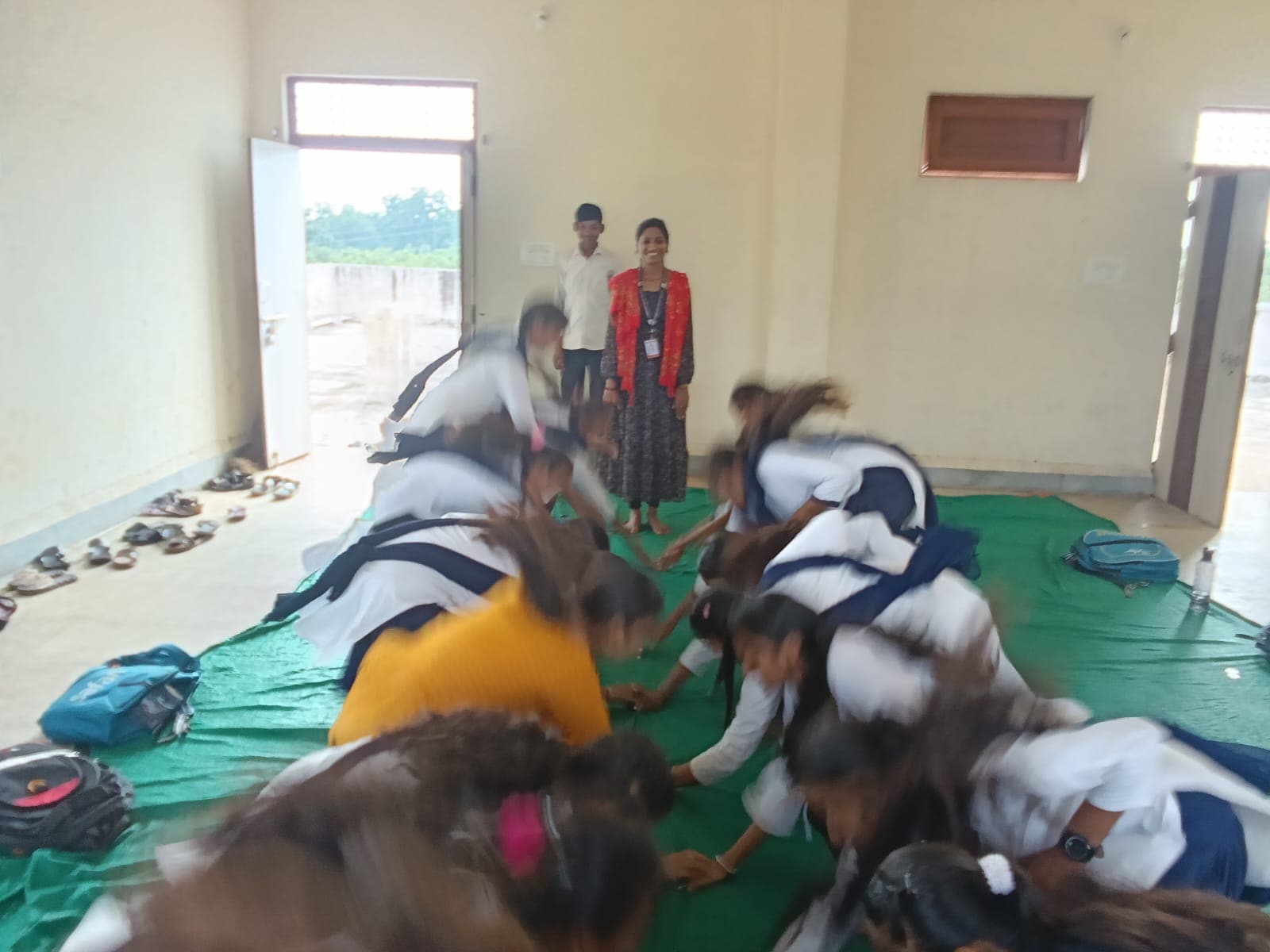 Young women leading a session in a village setting